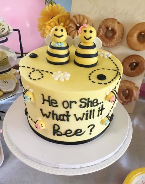 Gender reveal cake made with bees on top