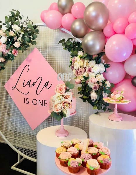 Half ballon arch with dessert table pink and floral theme