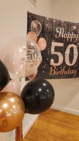 5oth birthday with balloons and banner, black, gold and pink themed